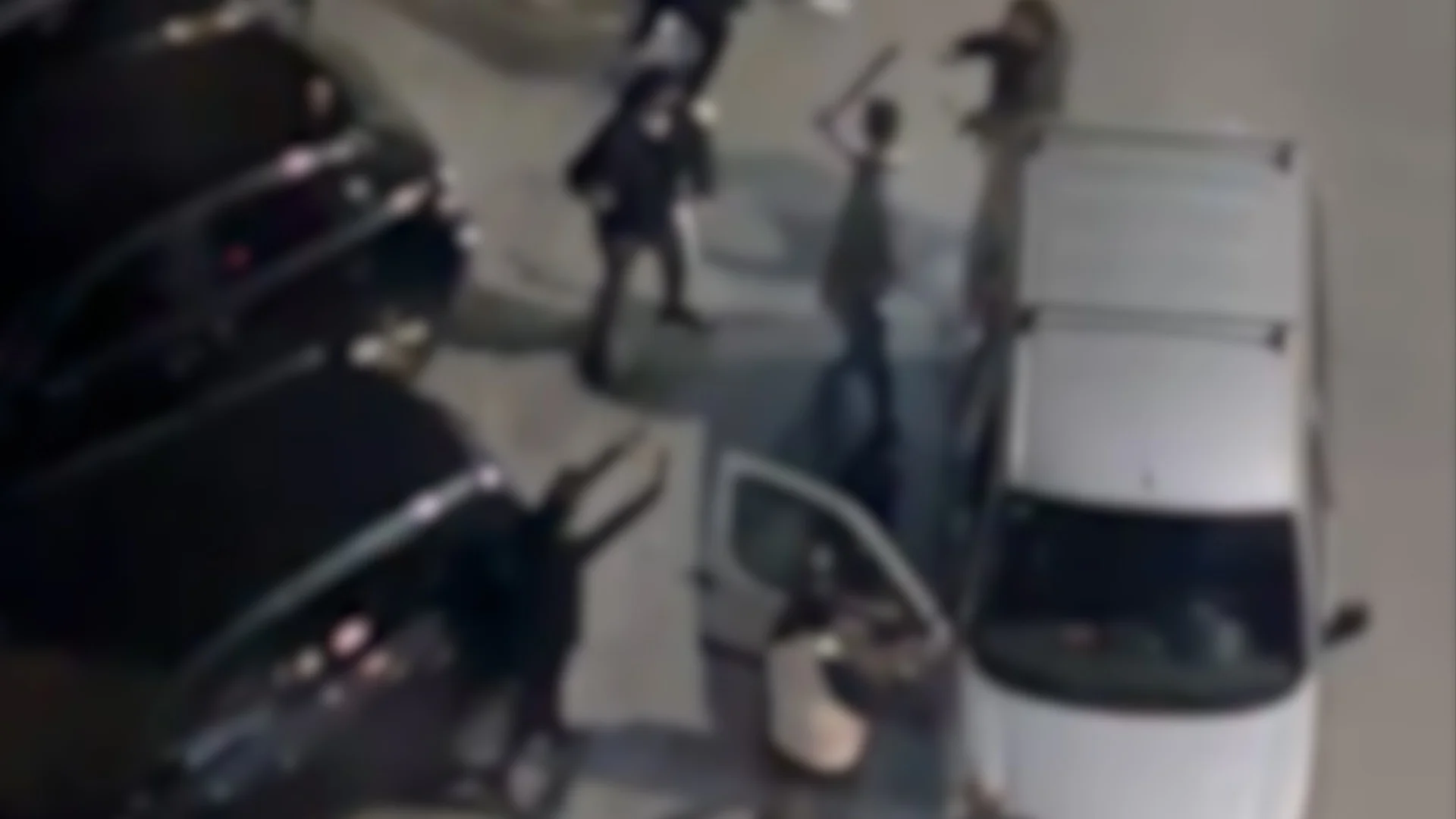 Residents take cover as youths armed with axes, curved swords and metal chains clash in Malaga neighbourhood