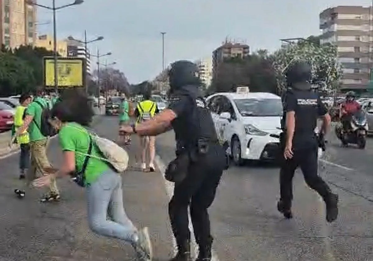Moment riot policeman shoves retired teacher, 68, to the ground at Spanish protest, sparking internal probe